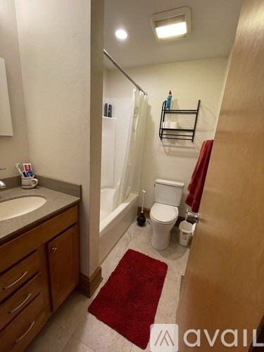 A bathroom with a sink, toilet, and bathtub.