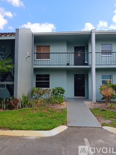A two-story apartment building with a balcony on the second floor.
