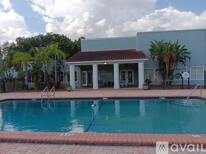 A pool in front of a house with a sign that says "available".