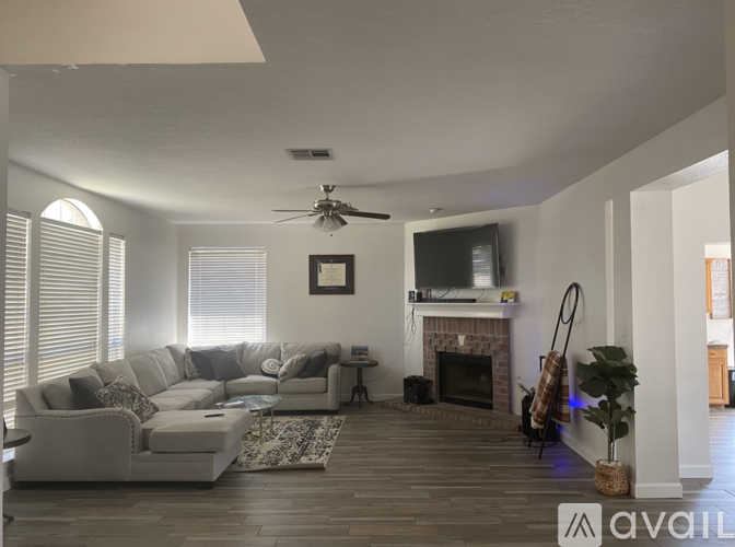 A living room with a fireplace and a television.