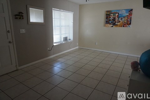 A room with a tiled floor and a painting on the wall.