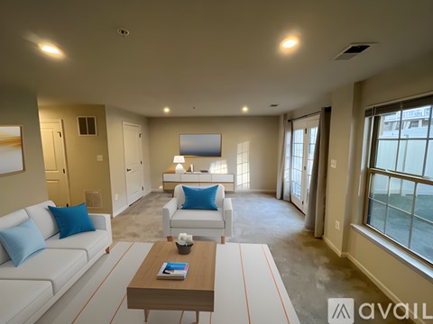 A living room with a white couch and a coffee table.