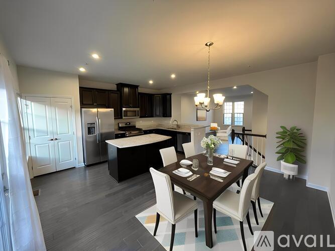A modern kitchen with a dining table set for four.