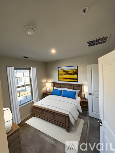 A bedroom with a large bed and a painting on the wall.