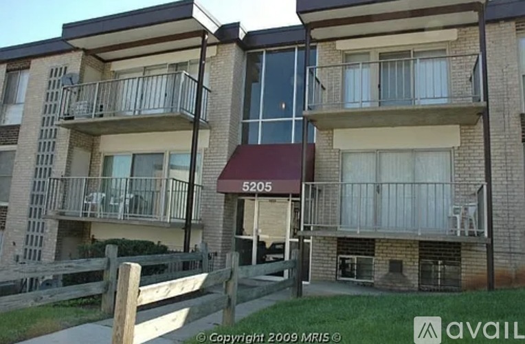 Apartment building with balconies and the number 5205 on the front.