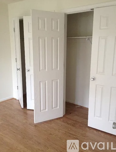 A room with a white door and a white closet.