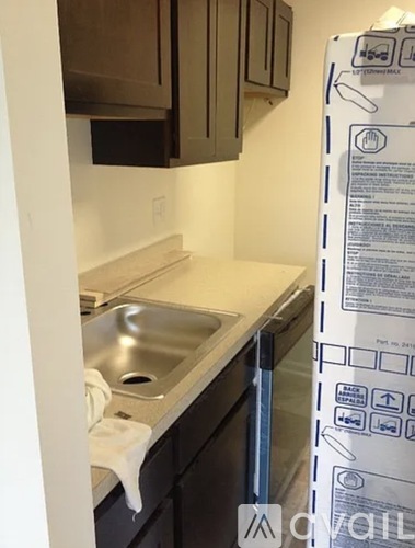 A white box is taped to the side of a kitchen.