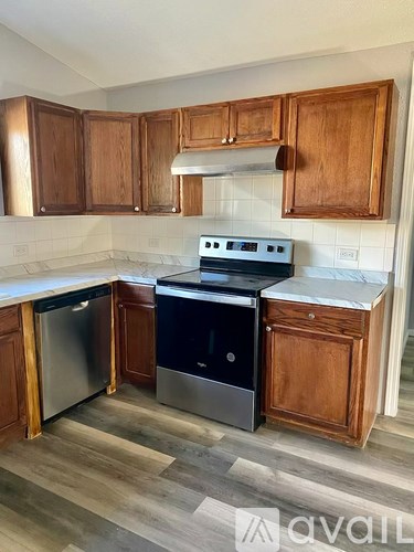 A kitchen with wooden cabinets and a white countertop.