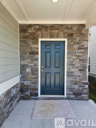 A blue door is set in a stone wall.