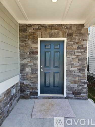 A blue door is set in a stone wall.
