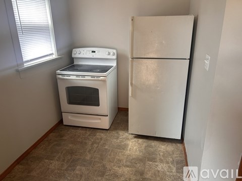 A white oven and fridge in a kitchen.