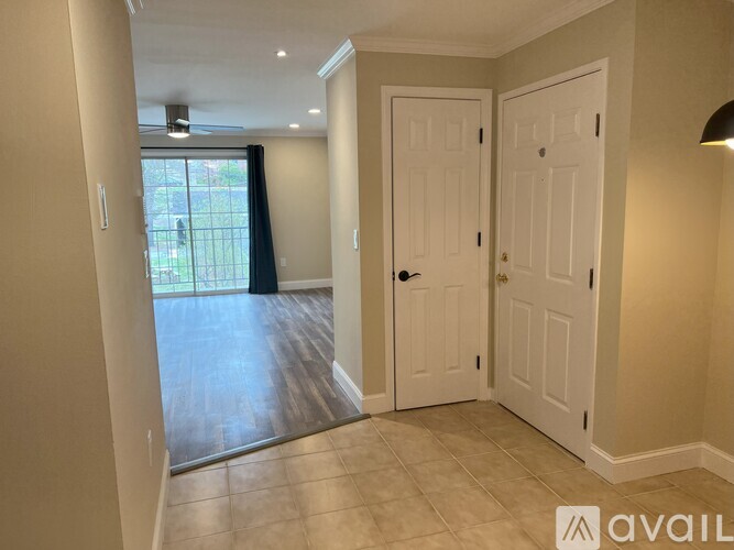 A room with a sliding glass door leading to a backyard.