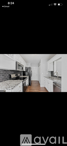 A black and white image of a kitchen with a countertop and cabinets.