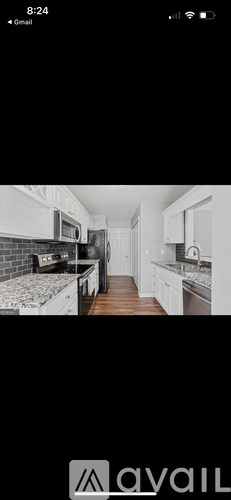 A black and white image of a kitchen with a countertop and cabinets.