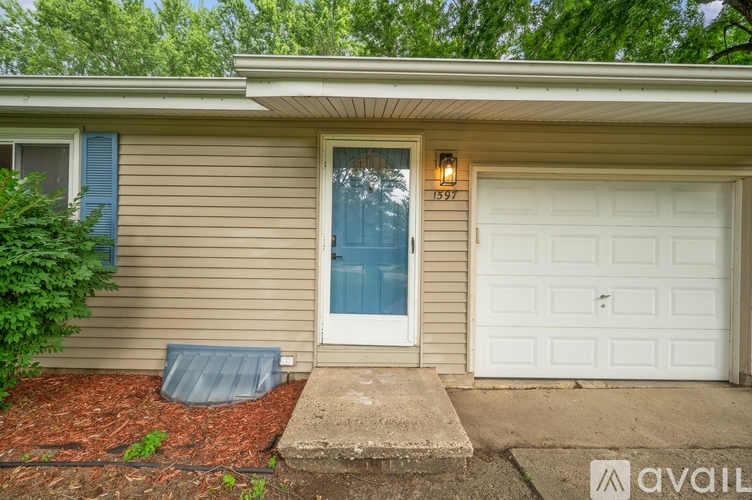 A house with a white garage door and a blue window.