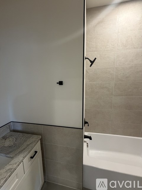 A bathroom with a tub and a sink.