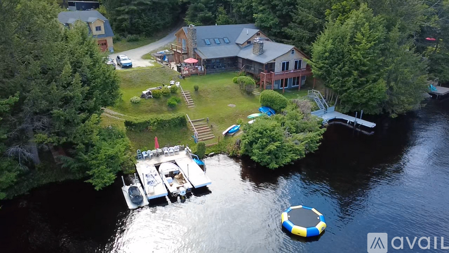 A house is surrounded by water and has a boat docked in front of it.