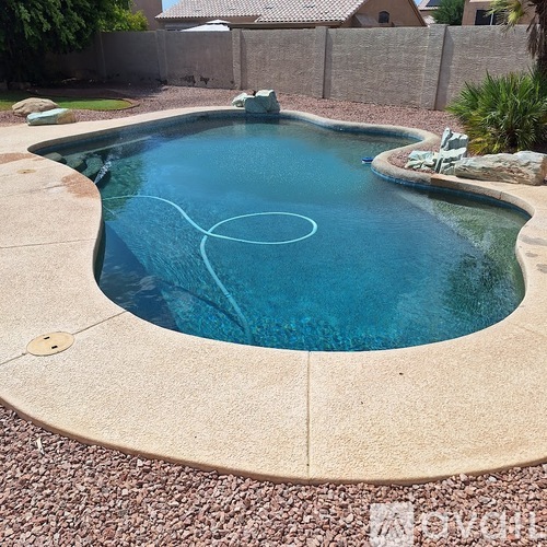 A small round pool with a blue tinted water.