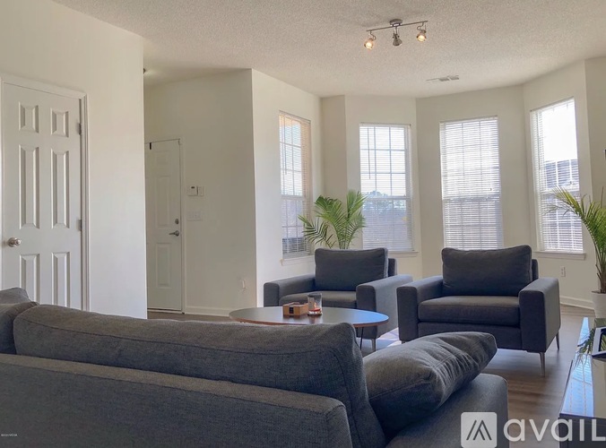 A living room with grey couches and a coffee table.