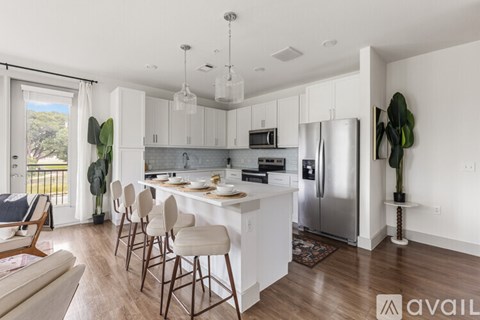 A modern kitchen with white cabinets and a large island.