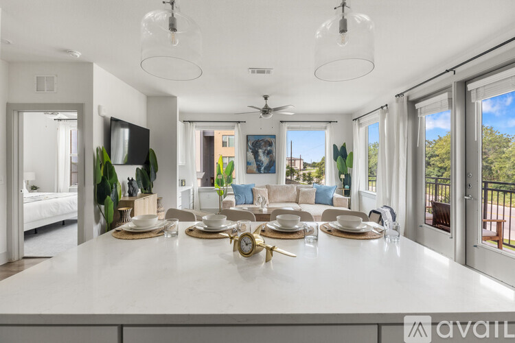 A modern dining room with a large table set for a meal.