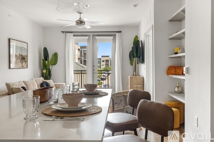 A dining room with a white table and chairs.