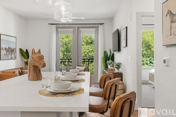 A dining room with a white table and chairs.