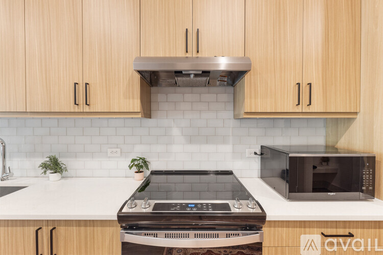 A kitchen with wooden cabinets and a black oven.