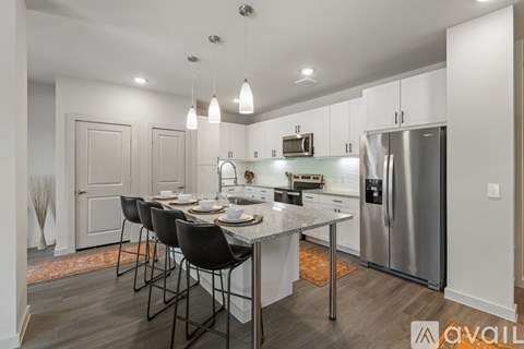 A modern kitchen with a dining table set for four.