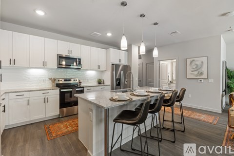 A modern kitchen with a dining table set for four.