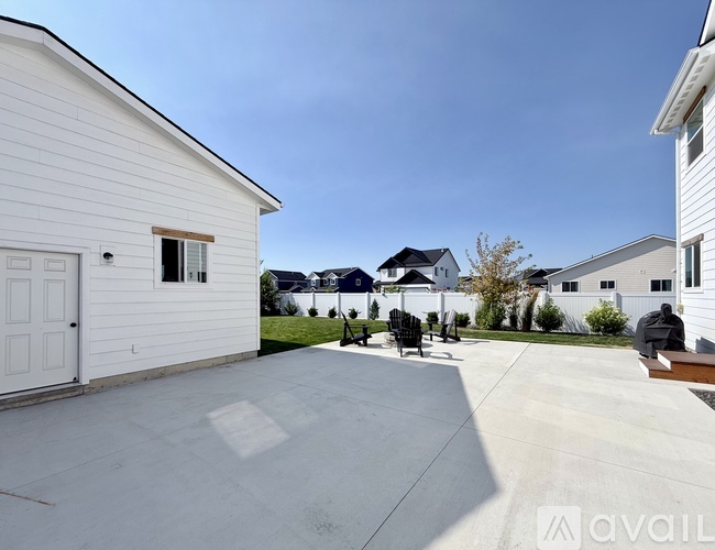 A white house with a driveway in front of it.