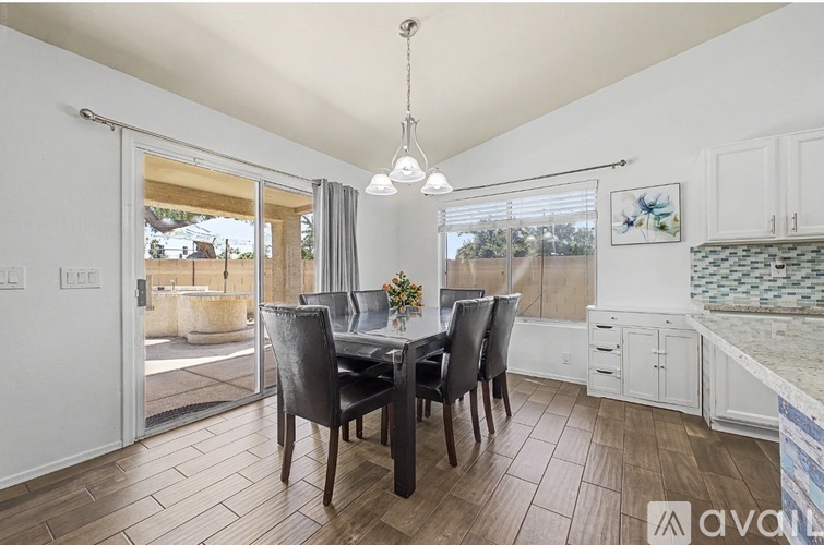 A dining room with a table set for four.