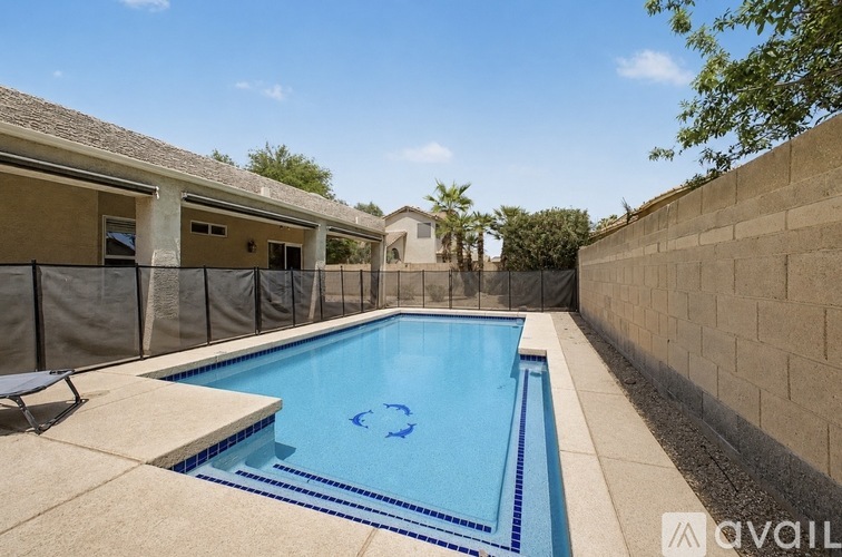 A pool with a blue tiled edge and a white tiled floor.