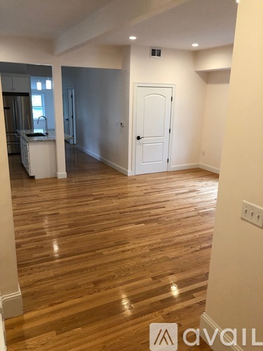 A room with wooden floors and a white door.