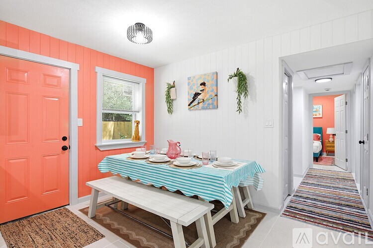 A dining room with a table set for two.