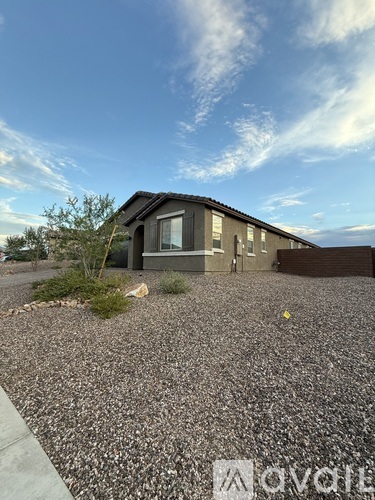 A house with a gravel driveway in front.