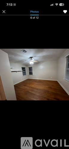 A room with wooden flooring and white walls.