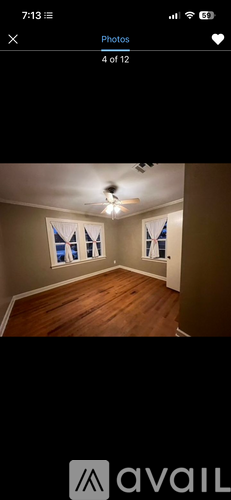 A room with wooden flooring and a ceiling fan.