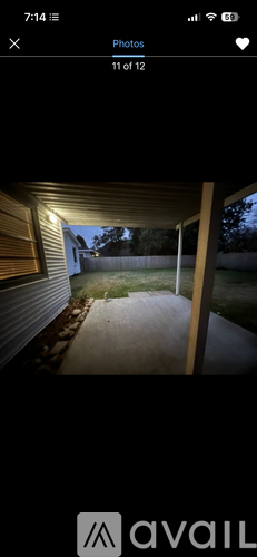A photo of a house's front porch with a concrete pathway leading to the entrance.