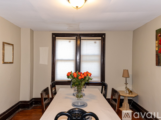 A dining room with a table set for four.