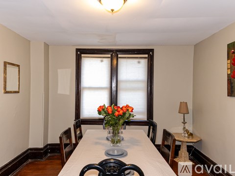 A dining room with a table set for four.