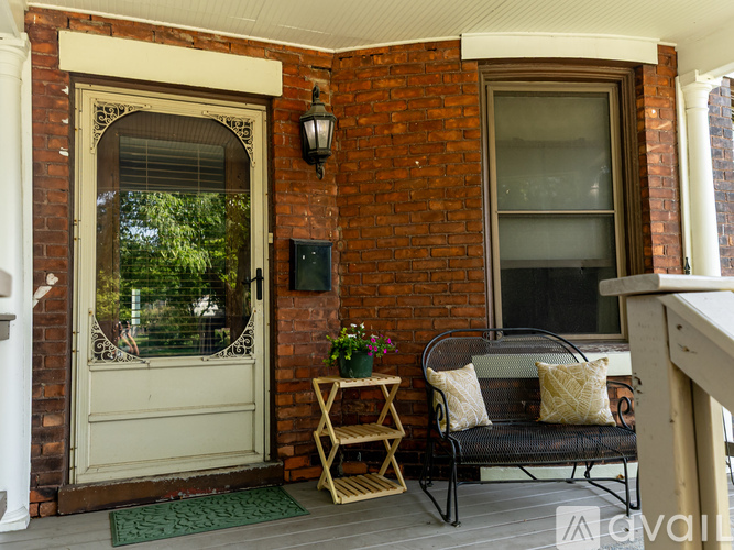 A small porch with a bench and a door.
