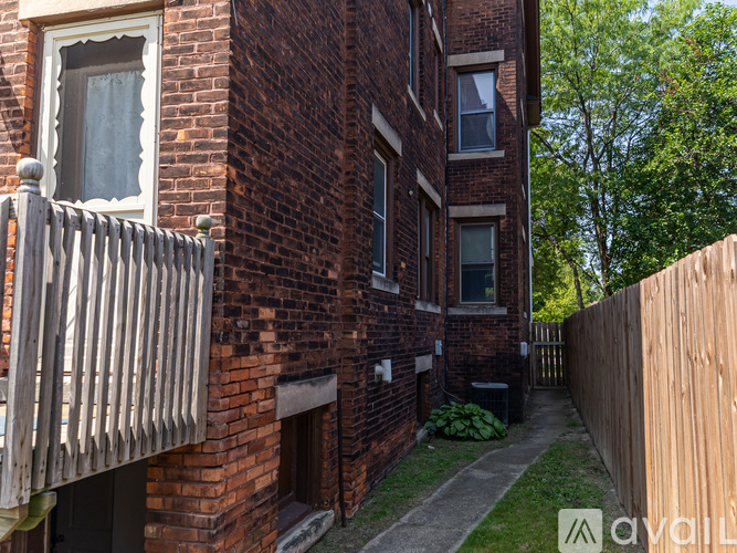 A brick building with a wooden fence in front.