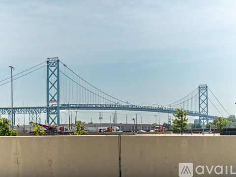 A large blue bridge spans the distance in the background.