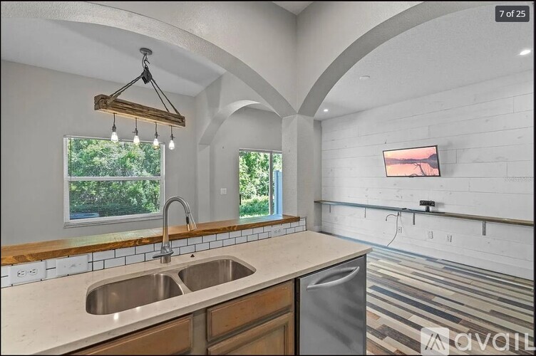 A kitchen with a sink and a window.