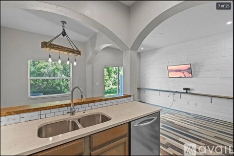 A kitchen with a sink and a window.
