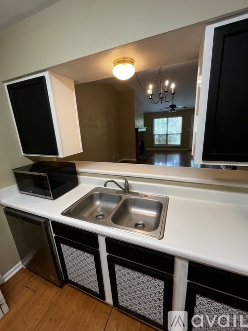 A kitchen with a black and white color scheme.