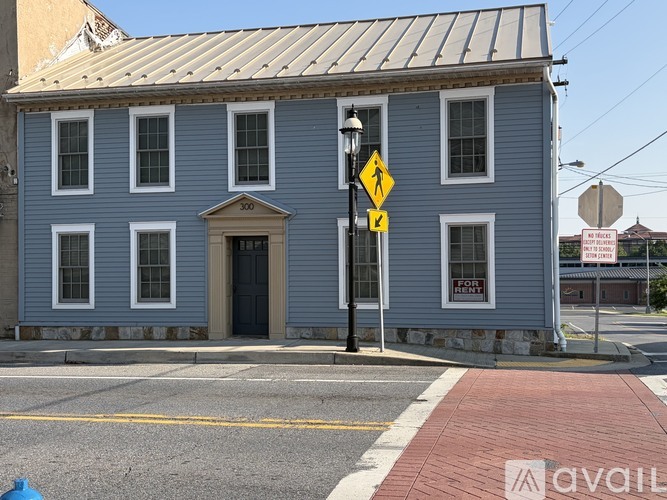 A blue building with a stop sign in front of it.