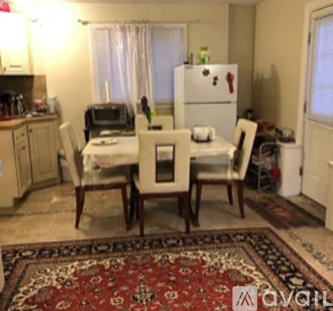 A kitchen with a table and chairs in the middle of the room.