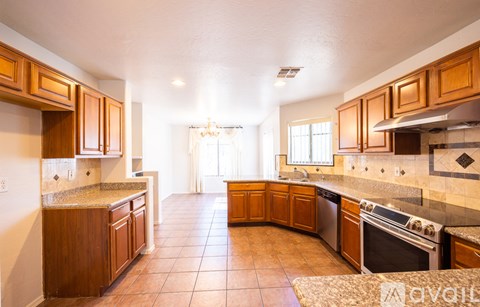 A kitchen with wooden cabinets and tile flooring.